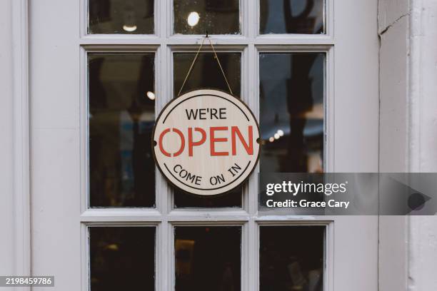 open sign hangs on store door - entrance sign stock pictures, royalty-free photos & images