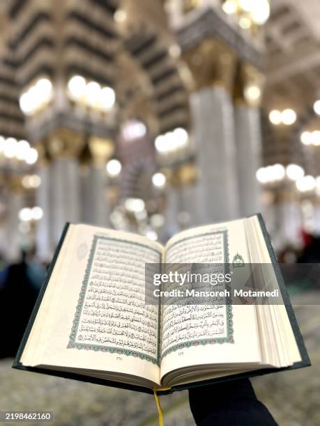 reading quran in the masjid al nabi, medina - koran stock pictures, royalty-free photos & images