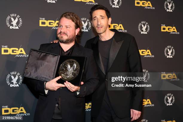 Brady Corbet, winner of a Directors Guild of America Feature Film Medallion for “The “Brutalist”, and Adrien Brody pose in the press room during the...