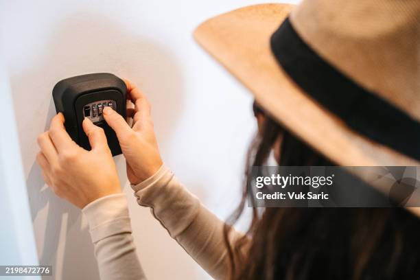 tourist taking key from lockbox - combination lock hand stock pictures, royalty-free photos & images