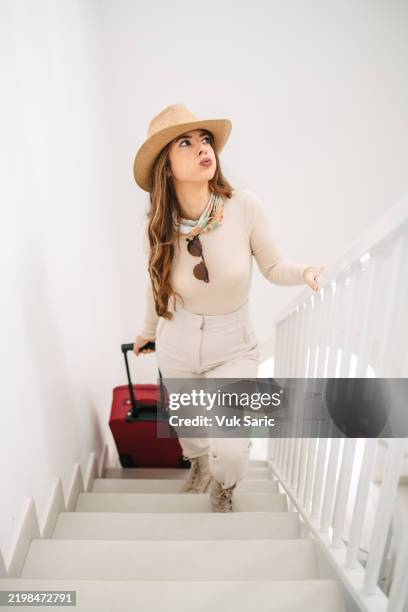 tired tourist walking up the stairs - samsonite luggage stock pictures, royalty-free photos & images