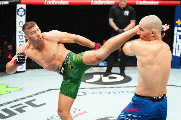 Dricus Du Plessis of South Africa kicks Sean Strickland in the UFC middleweight championship fight during the UFC 312 event at Qudos Bank Arena on...