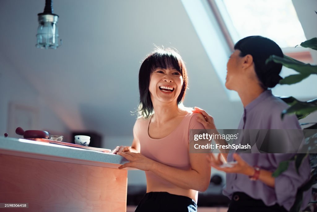 Two Women Sharing a Joyful Moment in a Modern Bright Room