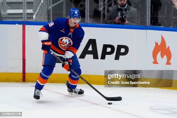 New York Islanders Defenseman Alexander Romanov controls the puck during the first period of the National Hockey League game between the Vegas Golden...