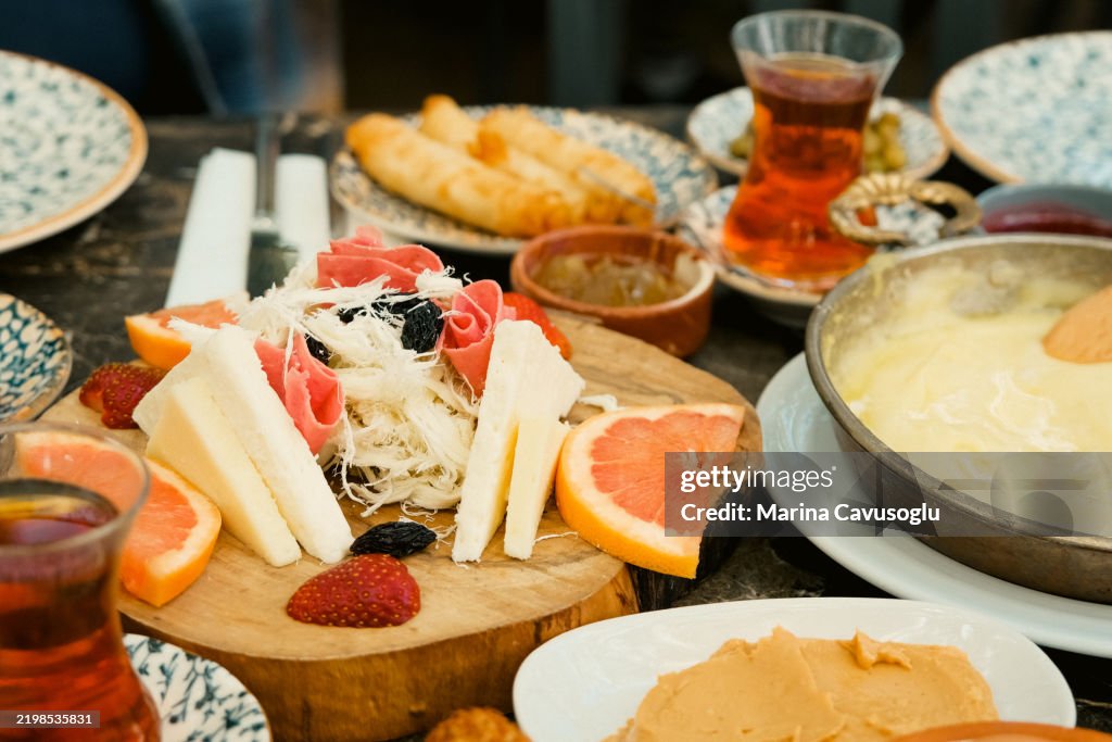 Traditional Turkish breakfast. Table full of plates with snacks. Cheese plate.