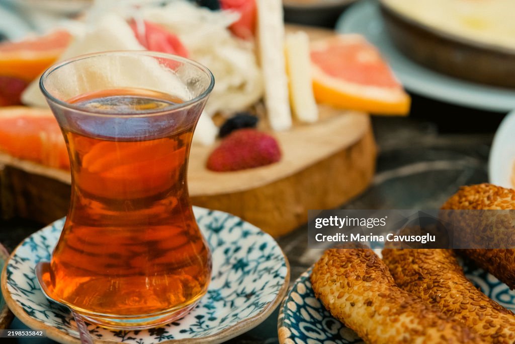 Traditional Turkish tea. Table full of plates with snacks. Cheese plate.