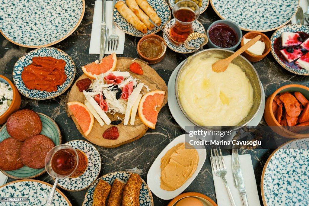 Traditional Turkish breakfast. Table full of plates with snacks. Cheese plate.