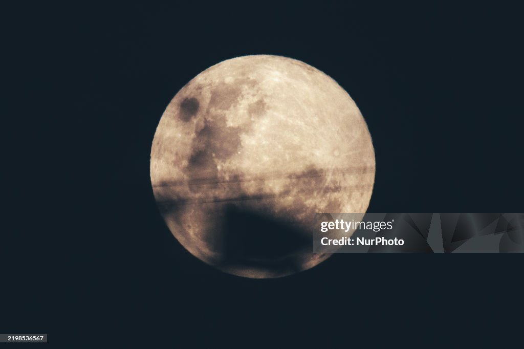 A full moon, called the Snow Moon, rises in Ungaran, Central Java ...