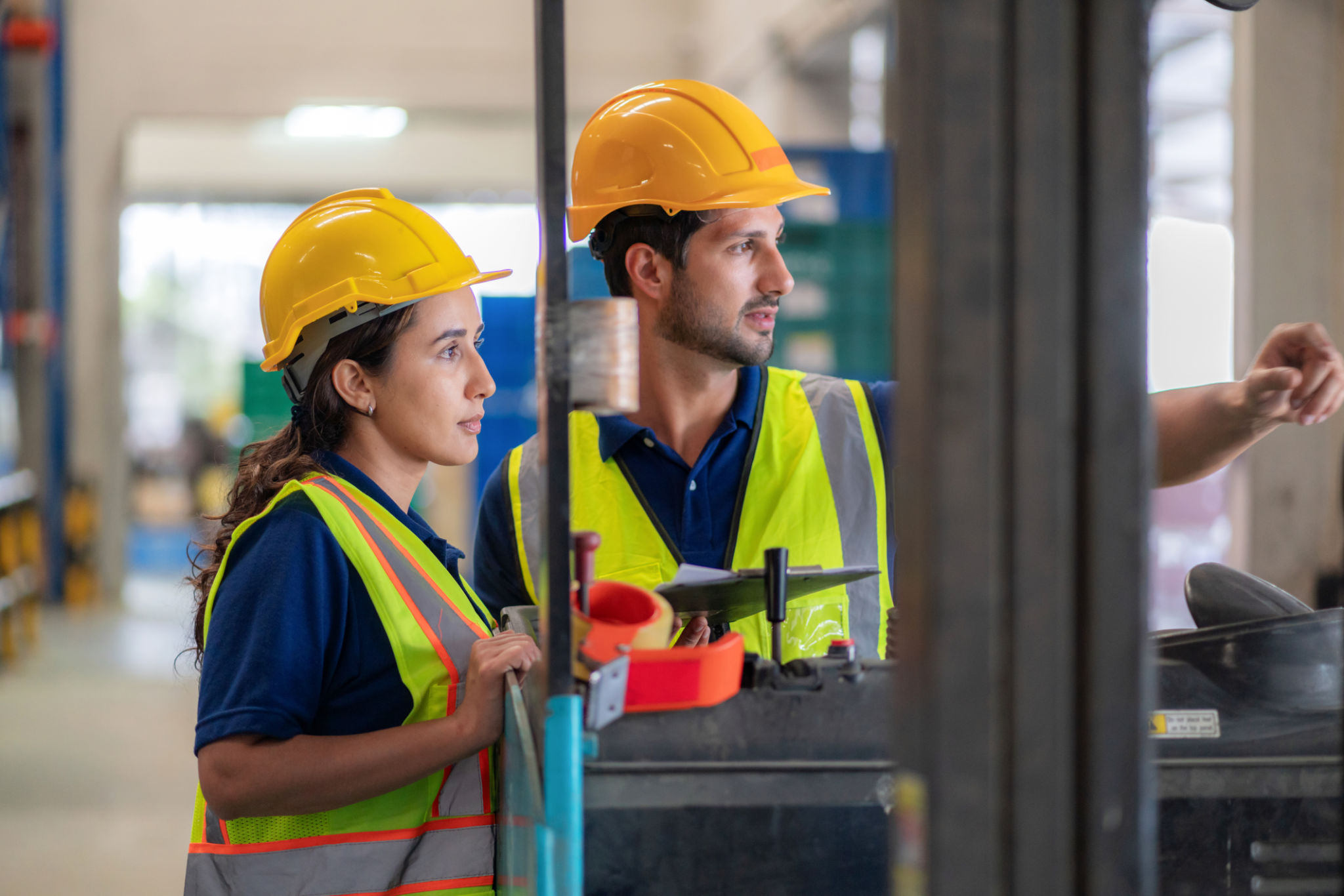 Professional warehouse team planning shipments using digital tools, ensuring efficiency and reliability in distribution. Workers stand in front of a forklift surrounded by pallets, emphasizing teamwork, logistics management, and operational success Professional warehouse team planning shipments using digital tools, ensuring efficiency and reliability in distribution. Workers stand in front of a forklift surrounded by pallets, emphasizing teamwork, logistics management, and operational success