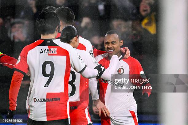 Feyenoord's Brazilian forward Igor Paixao celebrates with teammates after scoring the opening goal during the UEFA Champions League knockout phase...