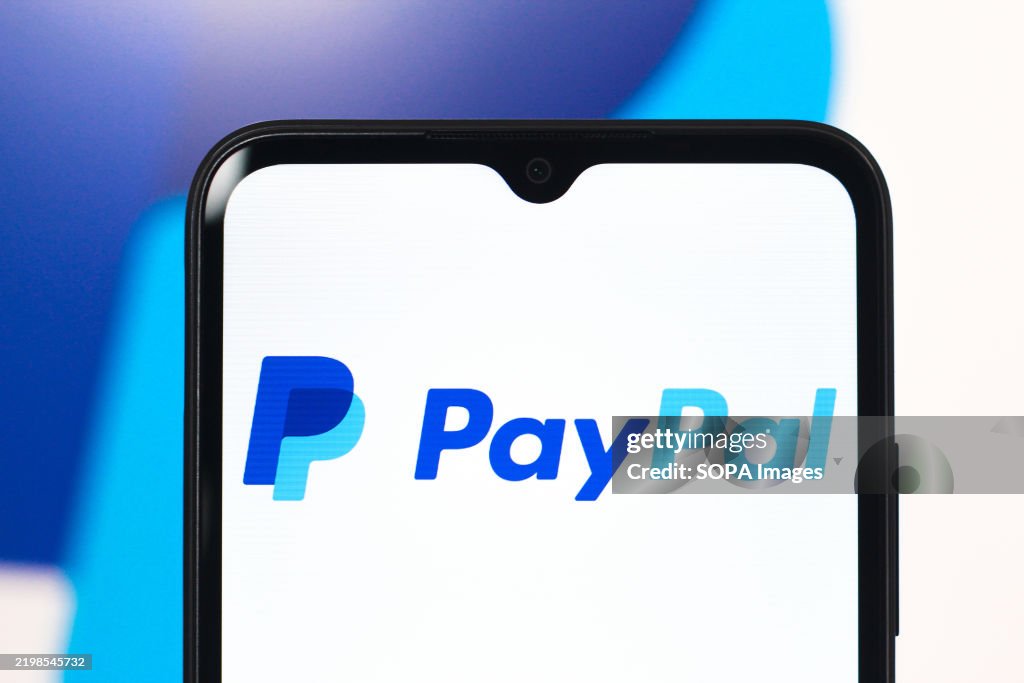In this photo illustration, the PayPal logo is seen...