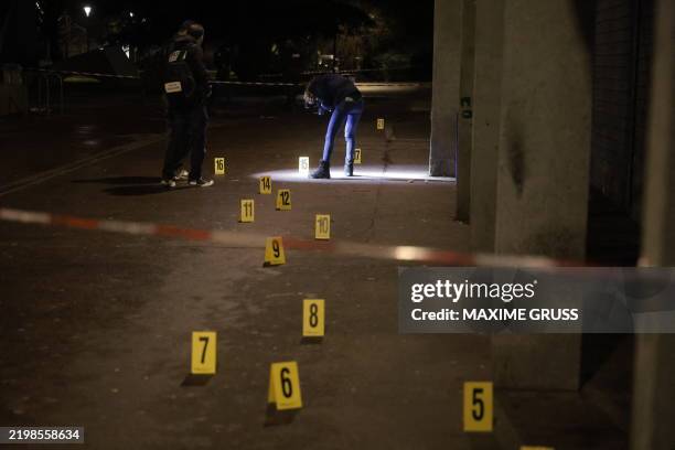 Police investigators work near the scene of an explosion at a bar where a grenade was thrown, in Grenoble, on February 12, 2025. At least nine people...