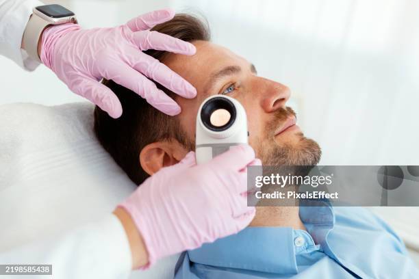dermatoscope inspection of patient’s by a dermatologist - mole skin stock pictures, royalty-free photos & images