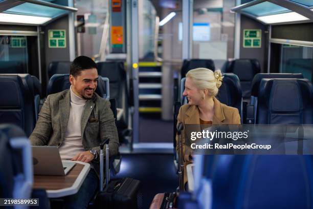 business colleagues traveling by train and working with laptop - rail transportation stock pictures, royalty-free photos & images