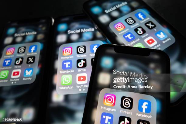 In this photo illustration, iPhone screens display various social media apps on the screens on February 9, 2025 in Bath, England. On top row left to...