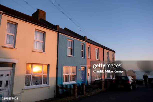 Sunset reflection in coastal terraced homes at Sandgate on 1st February 2025 in Folkestone, United Kingdom. Folkestone is a port town on the English...