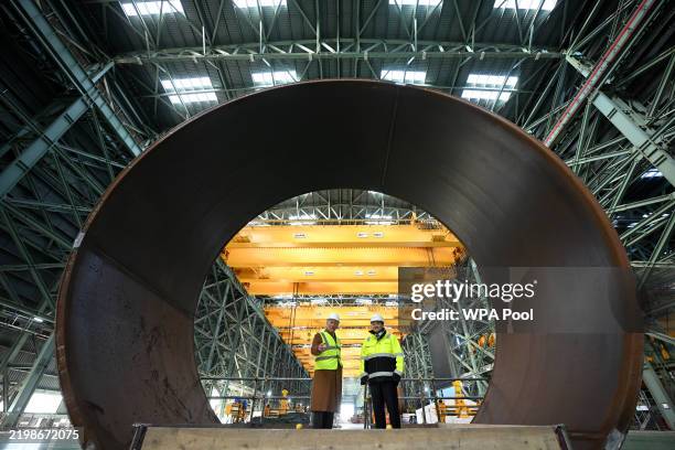 King Charles III and SeAH President Joosung Lee stand in the section of a Monopile foundation during a visit to at SeAH factory, on February 13, 2025...