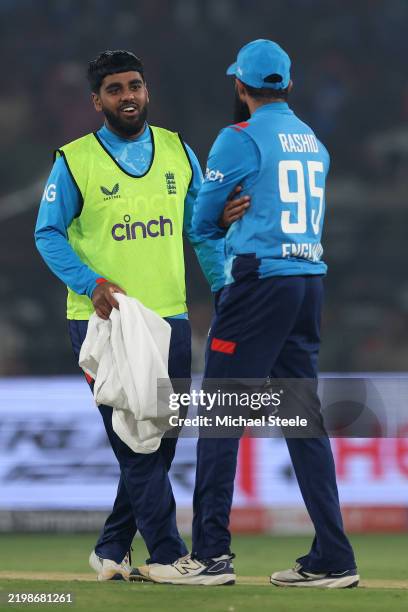 England substitute fielder Rehan Ahmed in conversation with Adil Rashid during the 2nd ODI match between India and England at Barabati Stadium on...