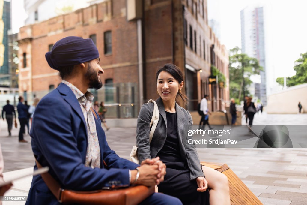 Professional Discussion Between Colleagues in City Center
