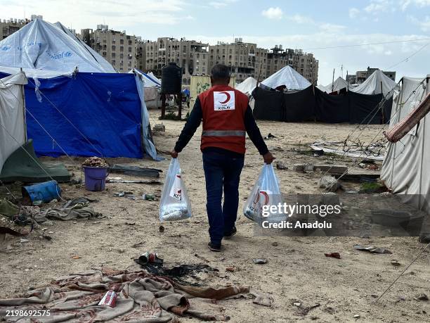 The Turkish Red Crescent team distributes aid to displaced families in Khan Yunis city in the southern Gaza Strip on February 13, 2025. Providing...