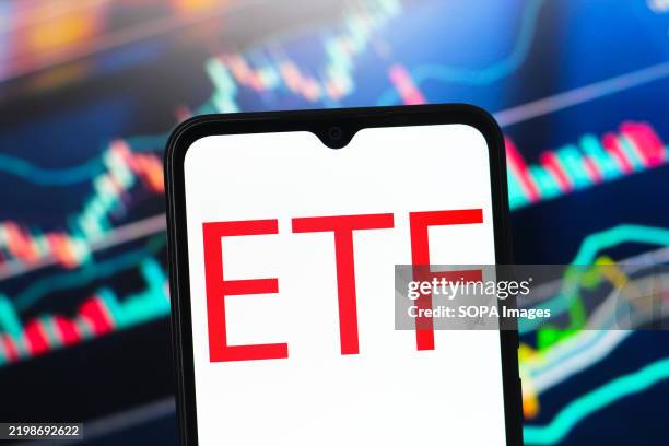 In this photo illustration, the Exchange Traded Fund logo is seen displayed on a smartphone screen.