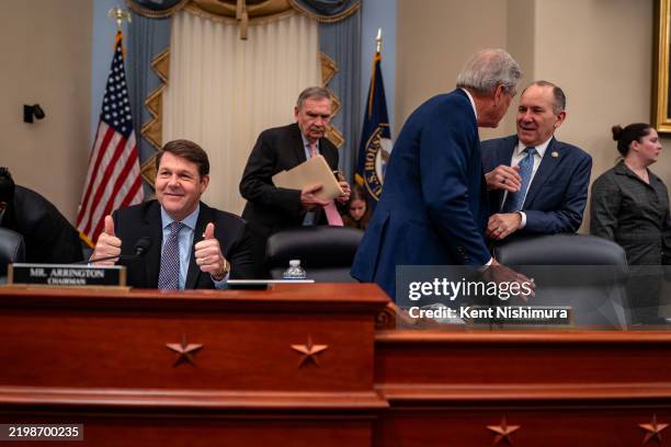 Chairman Rep. Jodey Arrington gives a thumbs up to press photographers as Rep. Ralph Norman chats with Rep. Lloyd Smucker before the start of a House...