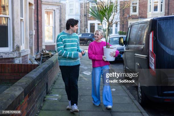 taking a new plant home - real couple stock pictures, royalty-free photos & images