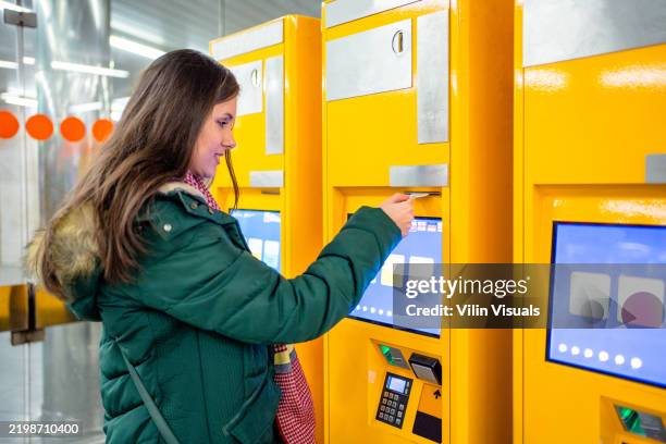 a woman buys a ticket for transport - airport bus stock pictures, royalty-free photos & images