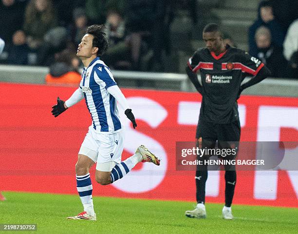 Real Sociedad's Japanese forward Takefusa Kubo celebrates scoring his team's second goal during the UEFA Europa League knockout round play-off first...