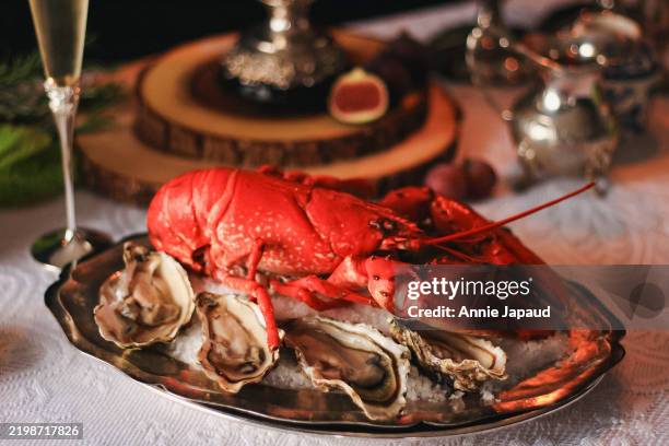 cooked lobster on silver platter with oysters, fancy luxury dining setting and closeup, selective focus - lobster restaurant stock pictures, royalty-free photos & images