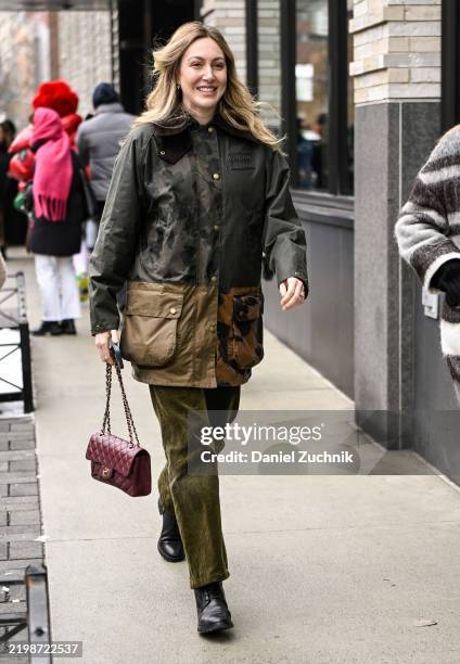 Guest is seen wearing a rustic black and tan jacket, green pants, black shoes and burgundy Chanel bag outside the Ulla Johnson show during NYFW F/W...
