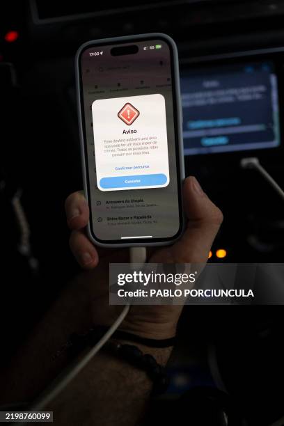 An Uber driver show his cellphone with warning from the Waze app that says: This destination is in an area that may have a higher risk of crime...