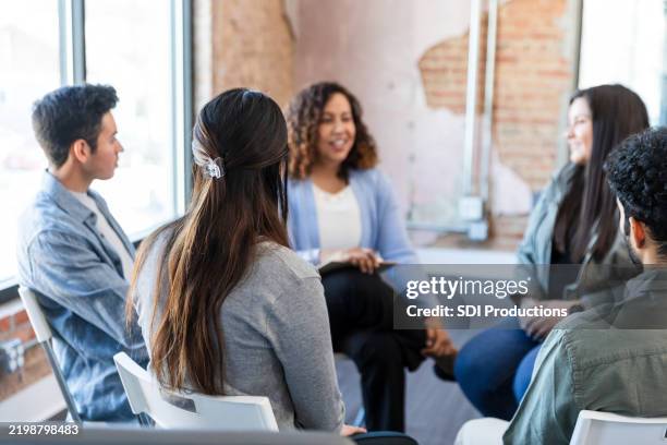 group therapy session: diverse adults in supportive discussion - group therapy stock pictures, royalty-free photos & images