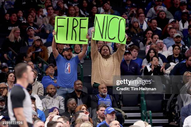 Dallas Mavericks fans hold up a sign referring to Mavs general manager Nico Harrison during the game against the Sacramento Kings at American...