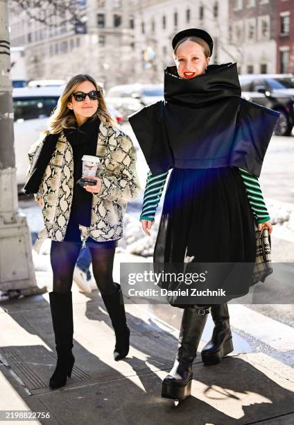 Jodi Kahn is seen wearing a snakeskin jacket, black sweater, black leather skirt, knee high boots and black sunglasses with Chloe King wearing a...