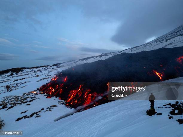 Lava flows from a fracture on the Mount Etna during an eruption of the volcano on February 14, 2025.