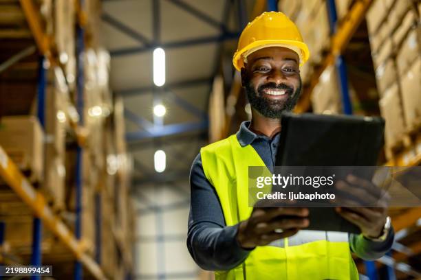 warehouse worker using tablet for inventory management and stock control - warehouse worker stock pictures, royalty-free photos & images