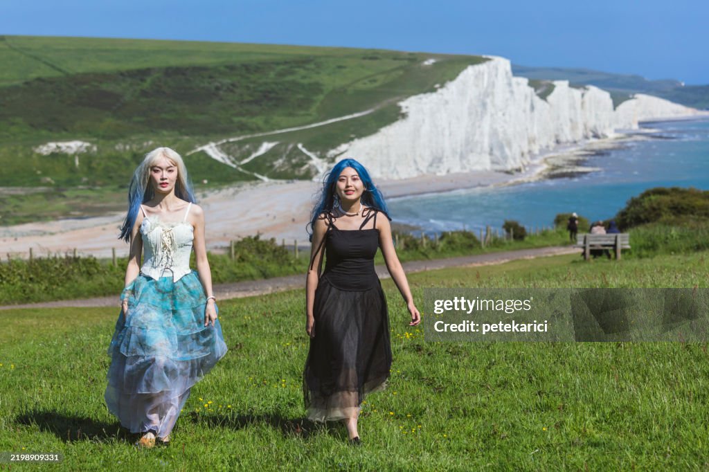 Young girls walking towards the Seven Sisters Cliffs, Brighton, United Kingdom