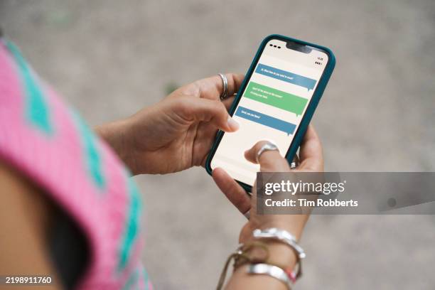 close up of woman using smart phone and text messaging - smartphone text message screen stock-fotos und bilder