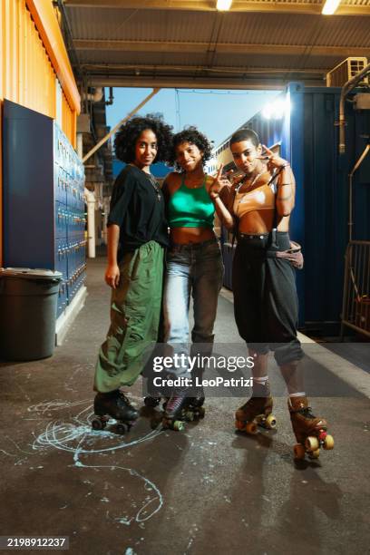 team with quad skates looking at camera - roller skates stock pictures, royalty-free photos & images