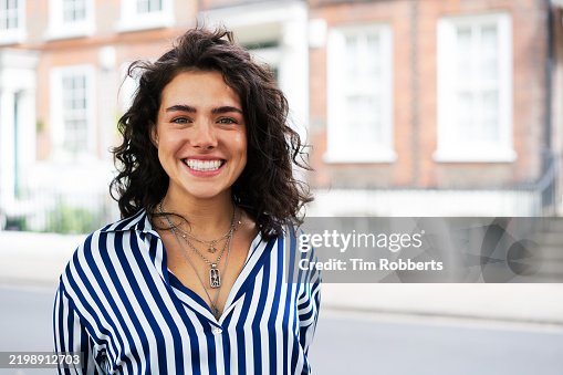 Woman smiling and looking at camera Woman smiling and looking at camera