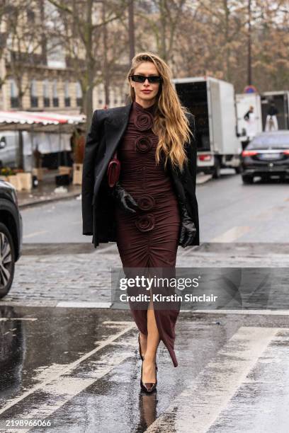 Maja Malnar wears an Elie Saab dress, Linda Farrow sunglasses, Saint Laurent shoes and jacket, Bottega Veneta bag and black leather gloves outside...