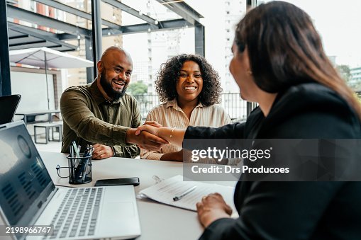 Couple closing real estate contract with real estate agent Couple closing real estate contract with real estate agent
