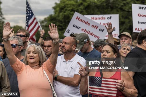 White South Africans supporting US President Donald Trump and South African and US tech billionaire Elon Musk gather in front of the US Embassy in...