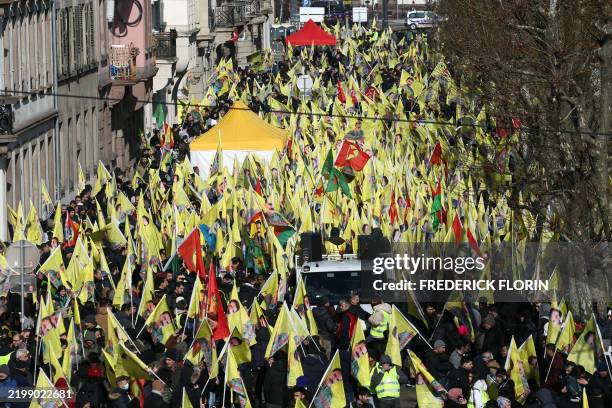 Kurds wave Kurdistan Workers' Party flags and flag depicting Kurdistan Worker's Party leader Abdullah Ocalan during a demonstration of several...