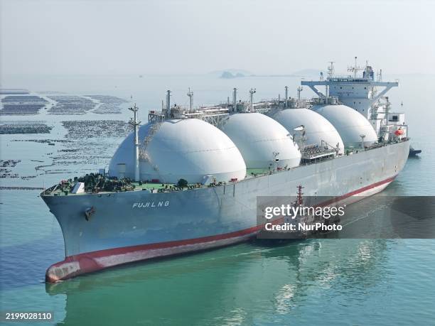 Large LNG carrier is assisted by a tugboat as it docks in Yantai, Shandong province, China, on February 14, 2025.