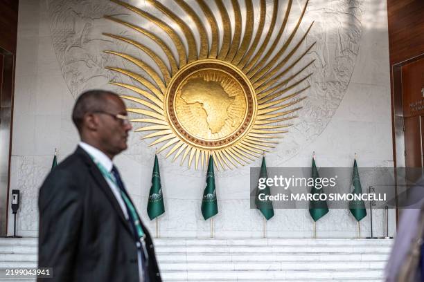 An AU delegate walks of past the grand lobby of AU headquarters ahead of the 38th African Union Summit, where leaders will elect a new head of the AU...
