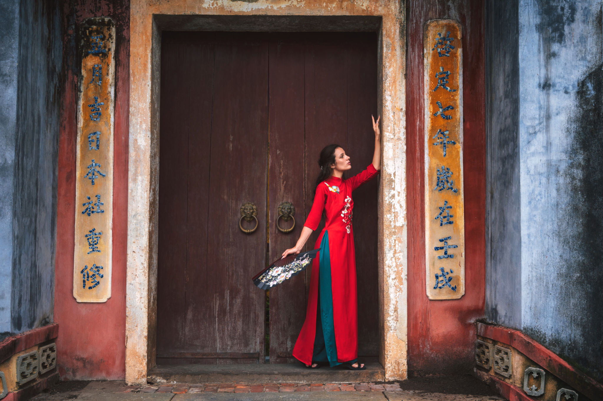 female traveler visiting asia. tourist in hat and traditional vietnamese dress visiting oriental buddhist temple in Hoi an female traveler visiting asia. tourist in hat and traditional vietnamese dress visiting oriental buddhist temple in Hoi an