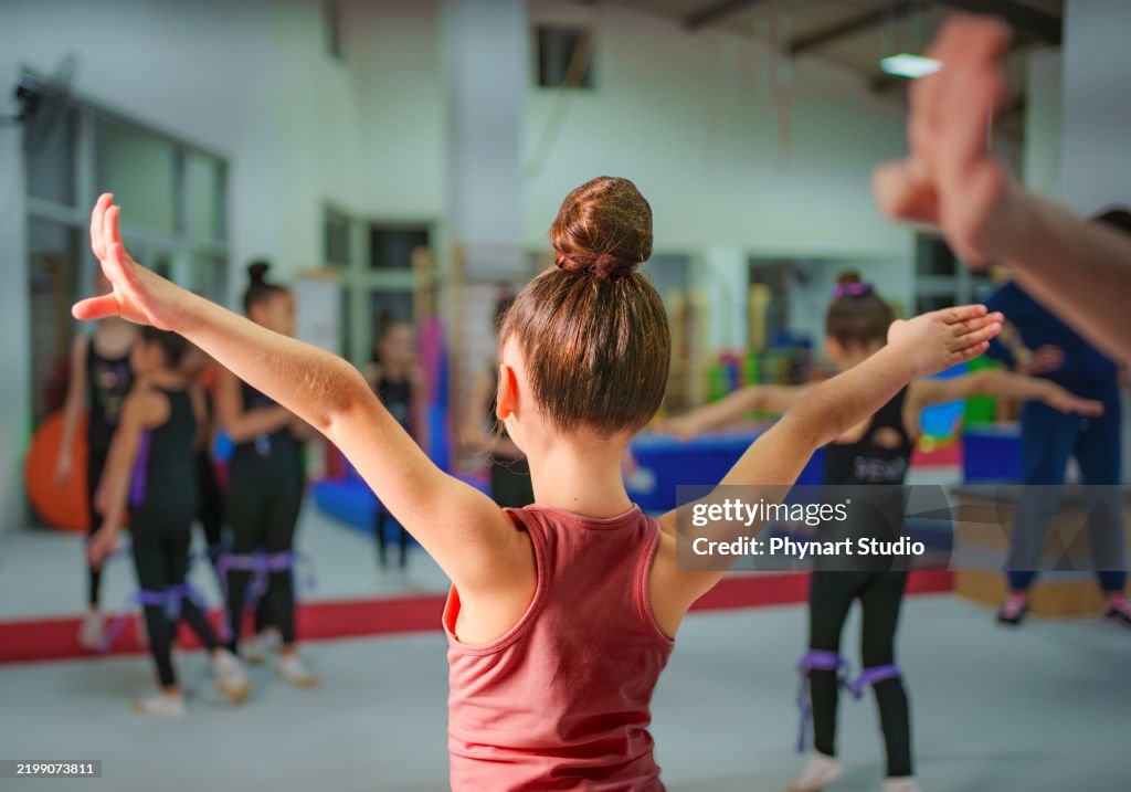 Young Gymnasts Practicing Ballet Poses in a Gymnastics Training Center