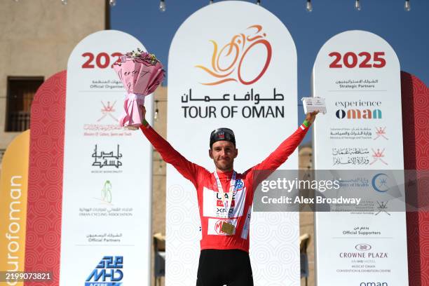 Adam Yates of Great Britain and Team UAE Team Emirates - XRG celebrates at podium as Red Leader Jersey and final overall race winner during the 14th...